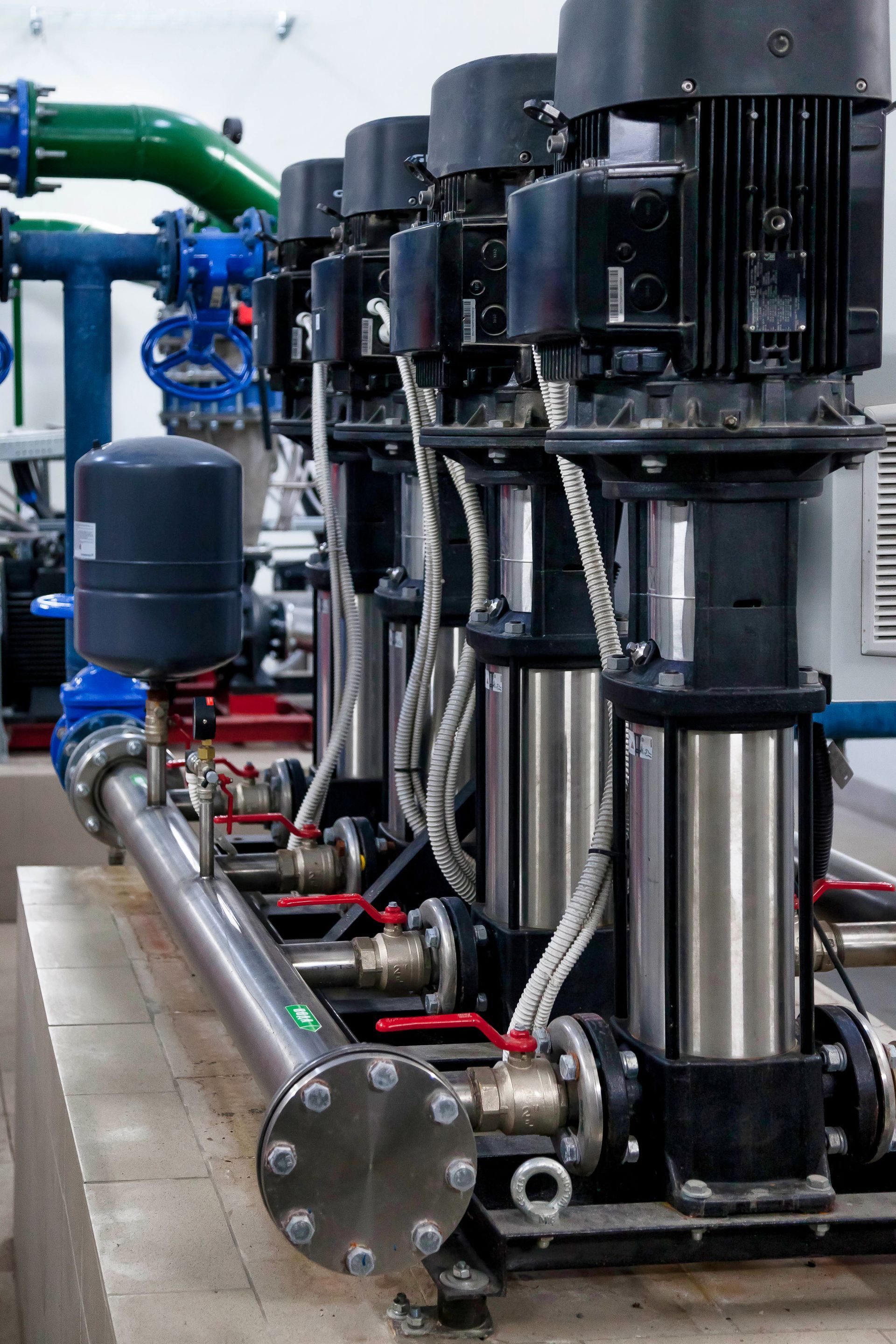 A row of water pumps are lined up in a factory in Tampa, FL.