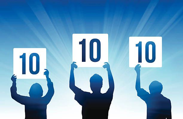 Three silhouettes holding up signs displaying the number