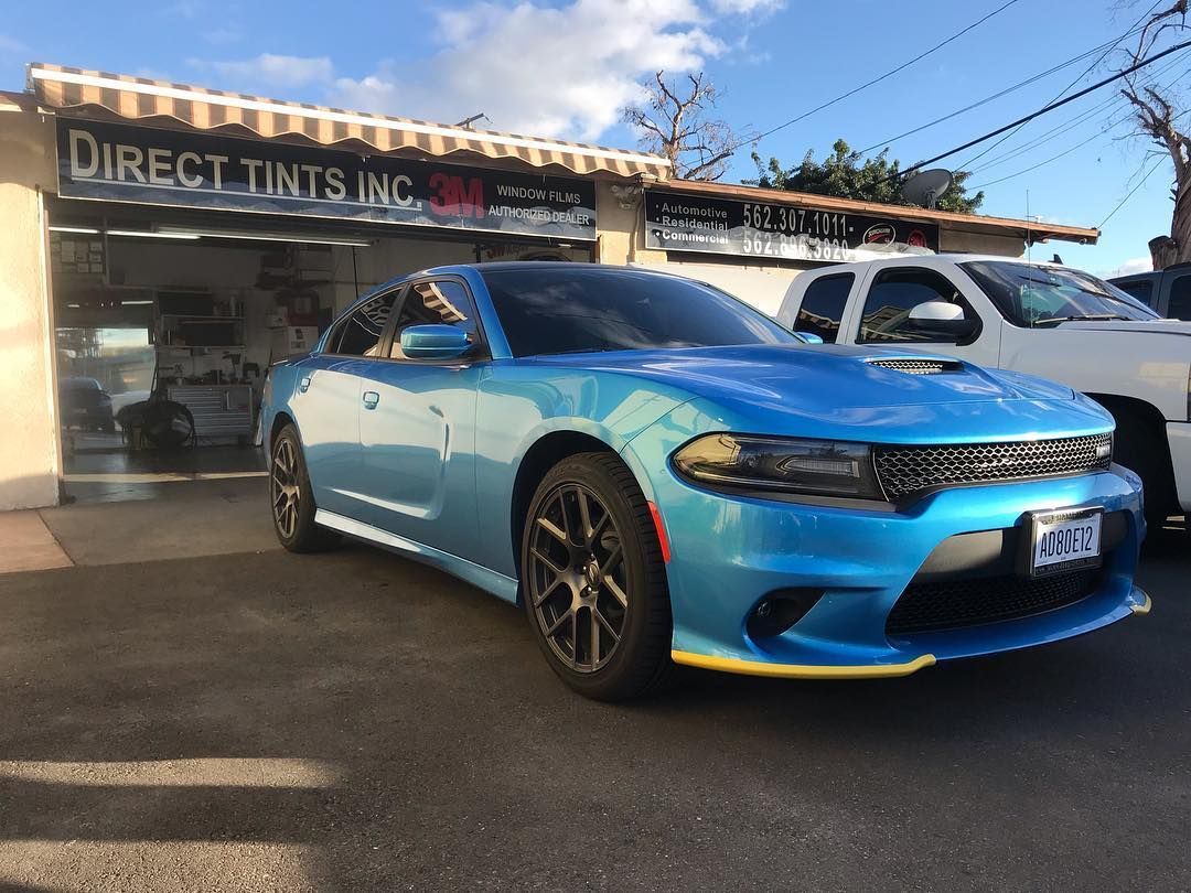 Blue Dodge Charger parked outside a 