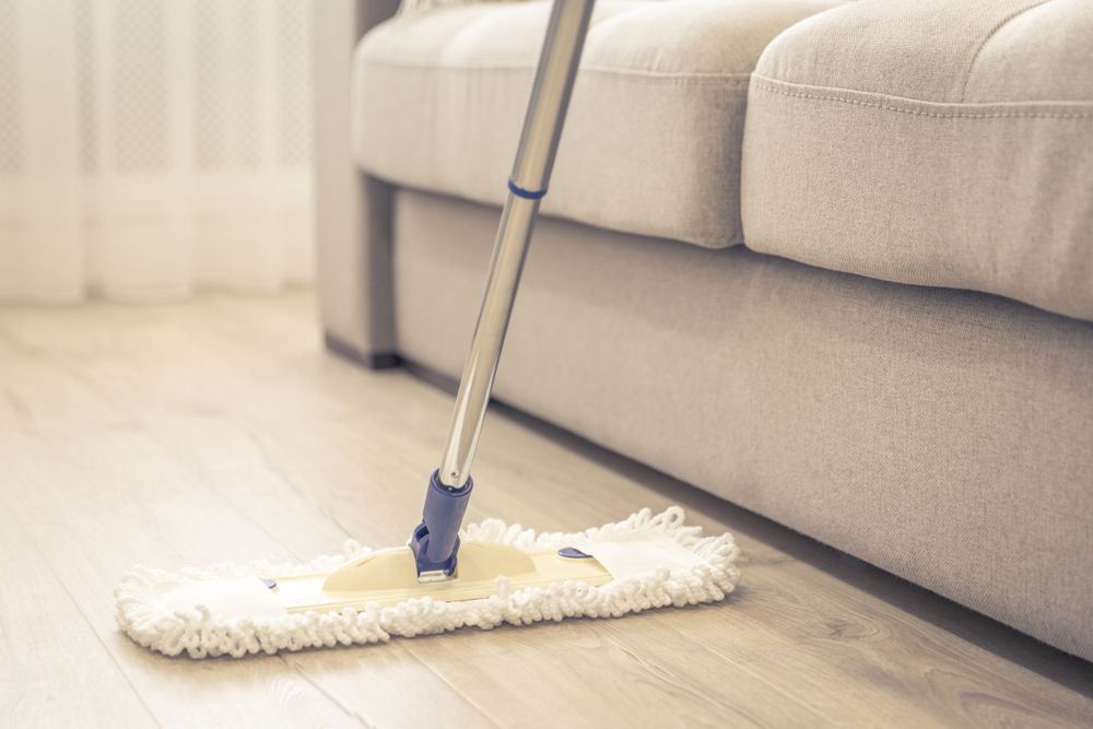 Two Women Are Cleaning a Table in an Office — Cleaning for Good in Elanora, QLD