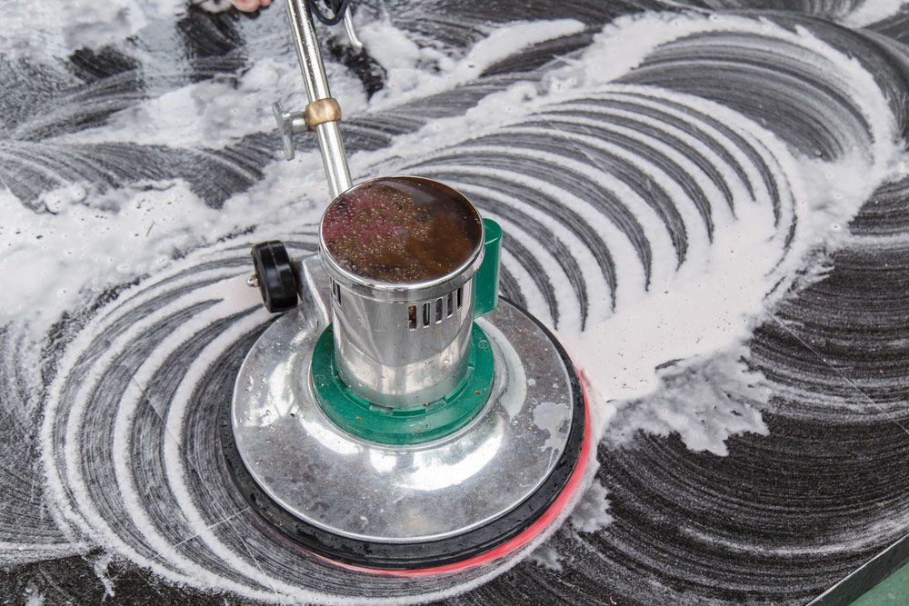 A Person is Using a Machine to Clean a Marble Floor — Cleaning for Good in Currumbin, QLD