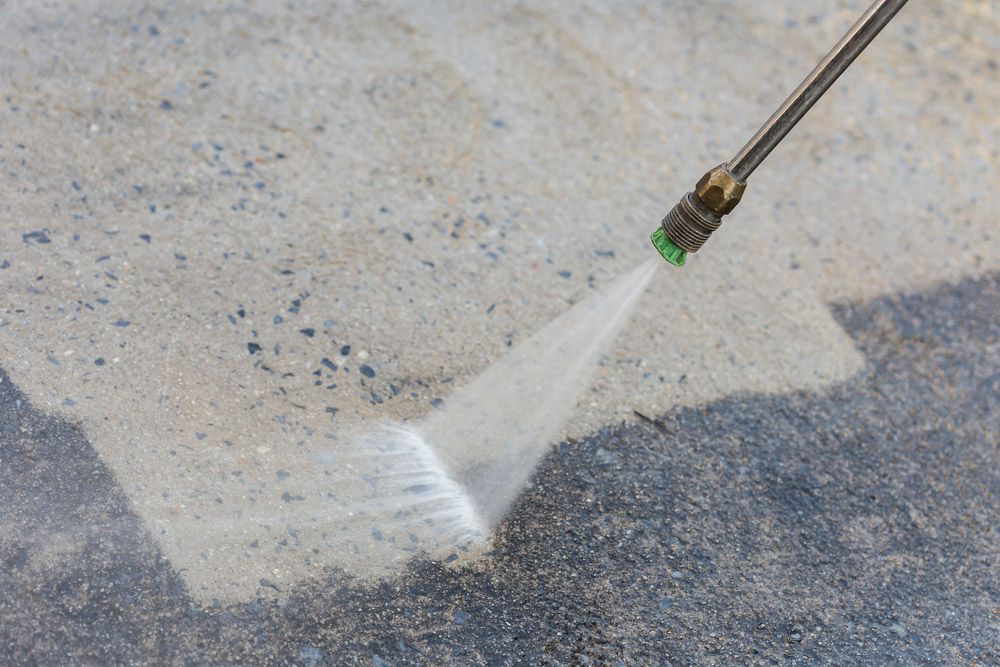 A High Pressure Washer is cleaning a dirty Patio — Cleaning for Good in Byron Bay, NSW