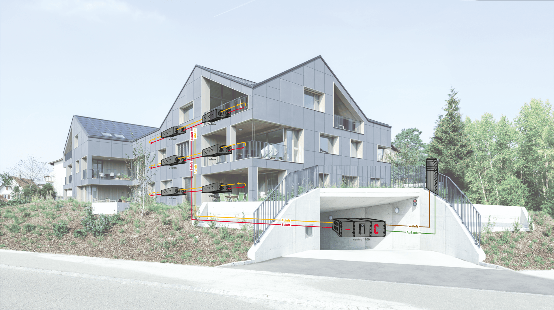 Modernes graues Gebäude mit Balkonen über einem Tunneleingang; im Hintergrund Grün und Bäume.