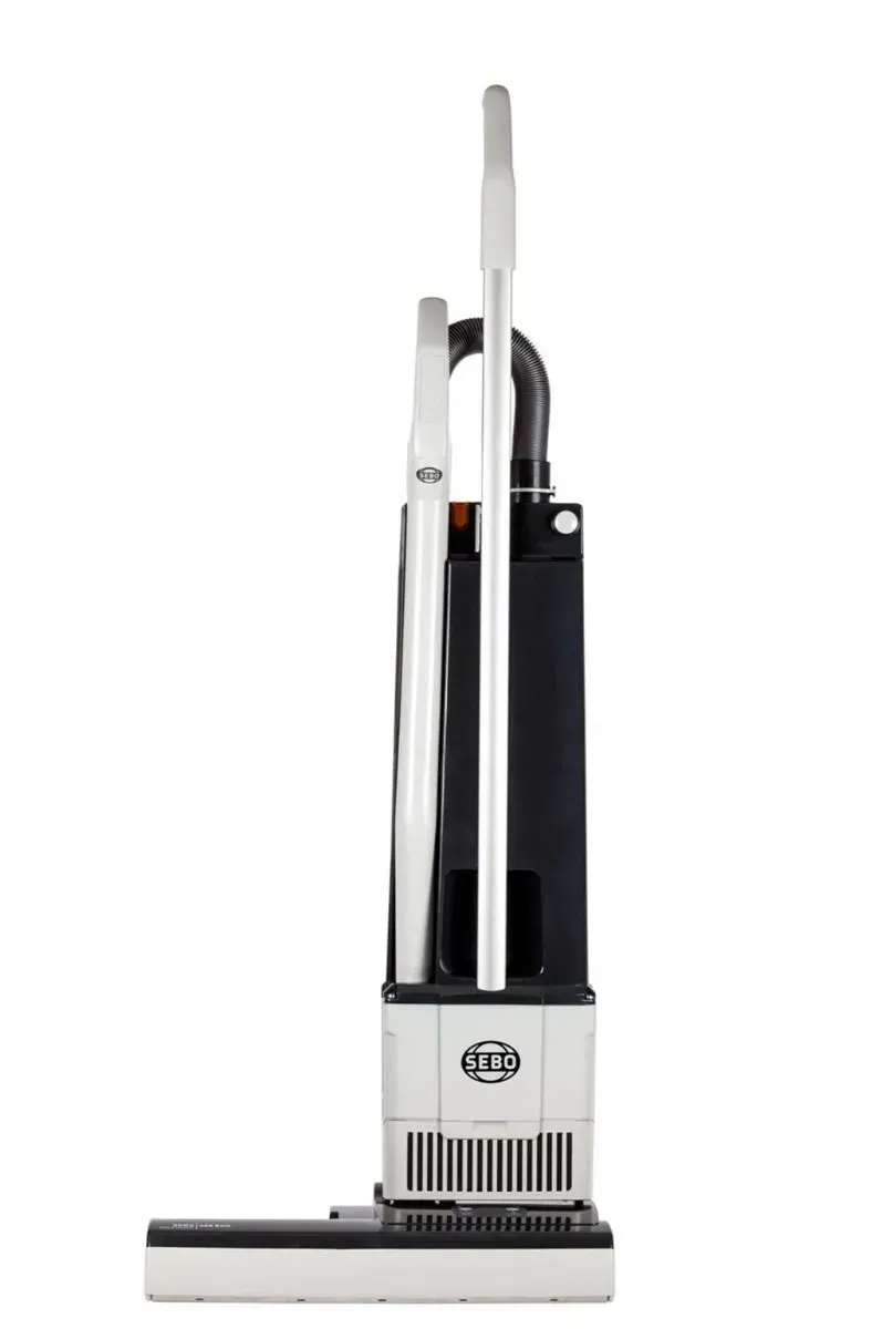 Upright vacuum cleaner, white and black, on a white background.