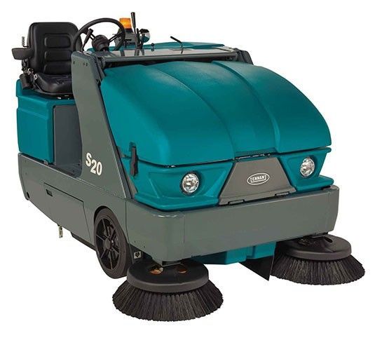 Teal and gray industrial sweeper with side brushes, driver seat, and headlights. 