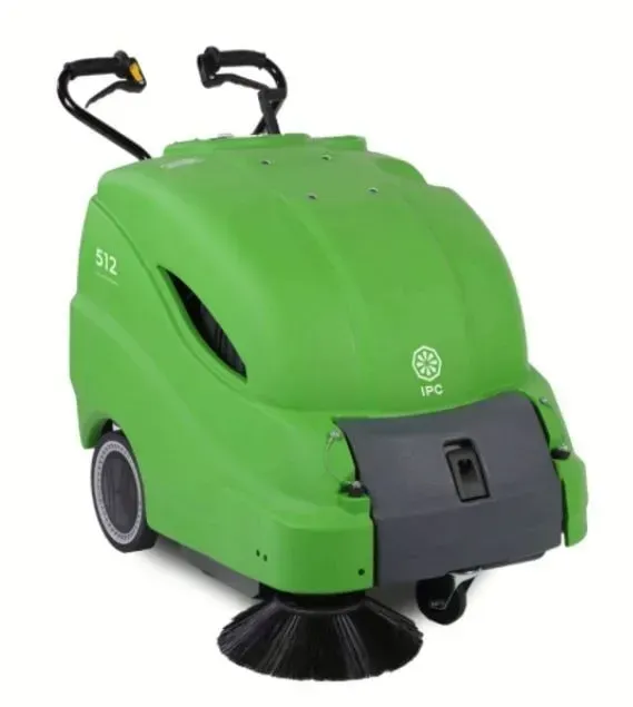 Green industrial floor sweeper with side brush and handle.