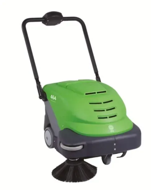 Green and black push-operated floor sweeper with a handle and rotating brush.