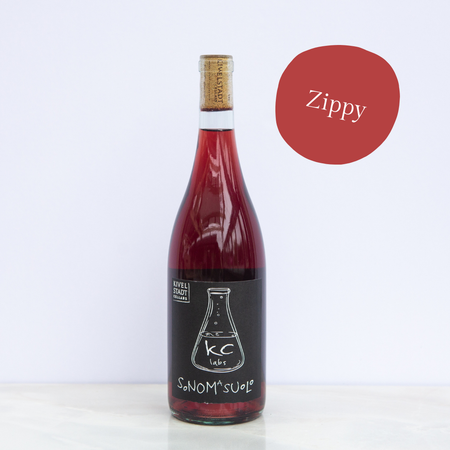 A bottle of zippy wine is sitting on a table
