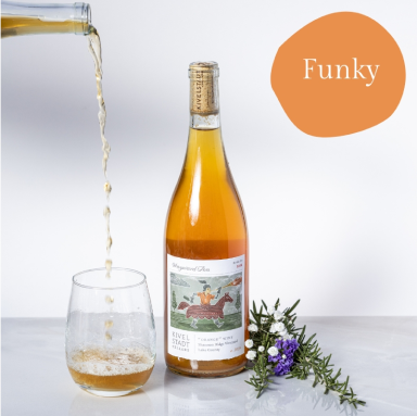 A bottle of funky wine is being poured into a glass