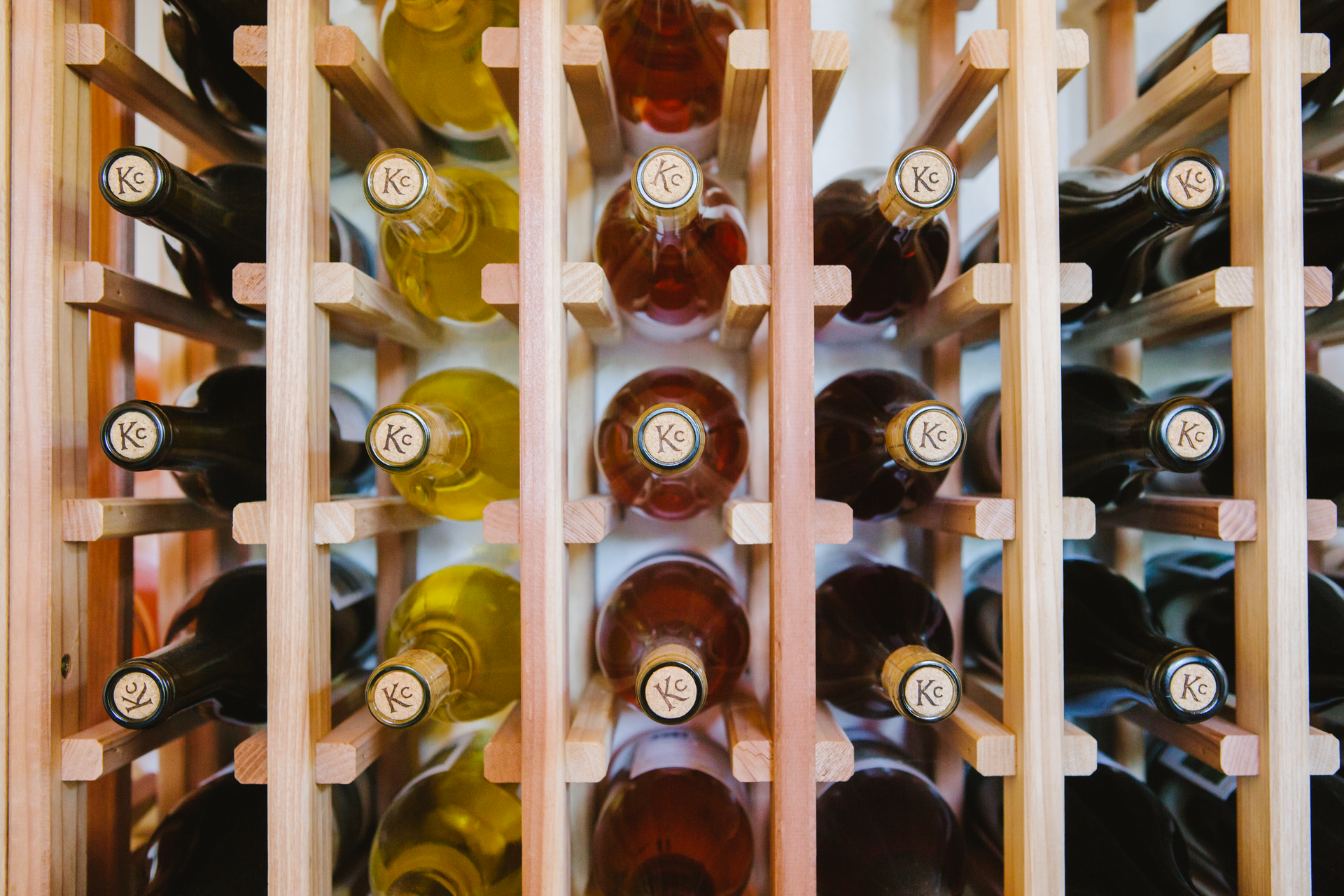 A wooden wine rack filled with bottles of wine.