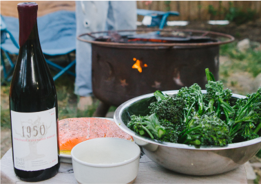 A bottle of 1950 wine sits next to a bowl of broccoli