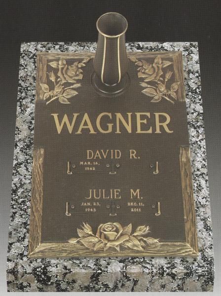 Bronze Wagner grave marker with vase and floral engravings on speckled granite base