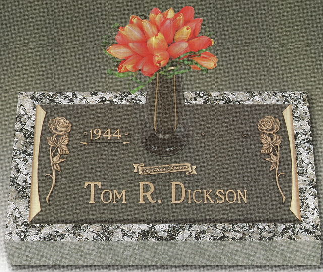 Gravestone plaque for Tom R. Dickson with flowers in a vase and the year 1944.