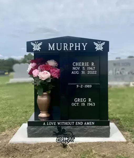 Murphy family gravestone with pink and white flowers in a grassy cemetery