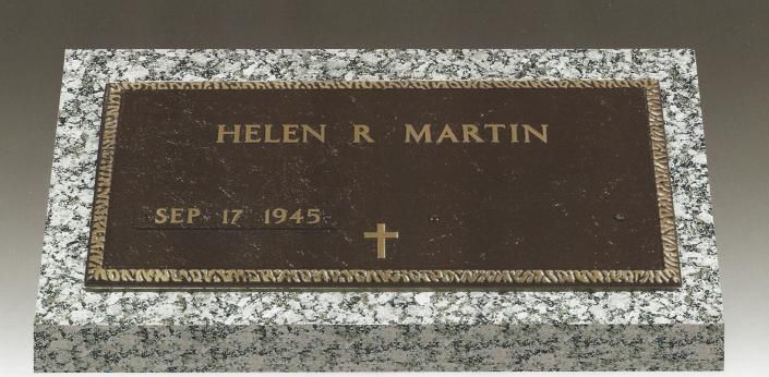 Flat granite grave marker engraved “HELEN R. MARTIN” with date “SEP. 17, 1945” and a cross.