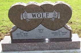 Heart-shaped double gravestone with the name WOLF engraved on top.