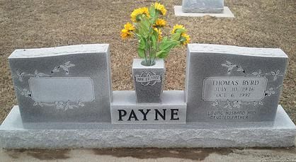 Payne family gravestone with flowers, featuring two gray headstones on a concrete base.