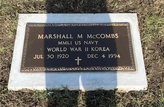 Bronze military grave marker for Marshall M. McCombs, U.S. Navy, with dates 1920–1994.