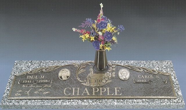 Gravestone marked “CHAPPLE” with a vase of colorful flowers on top