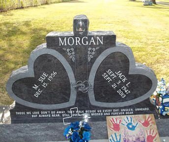 Heart-shaped Morgan gravestone in a cemetery, with a photo and engraved names on the stone.