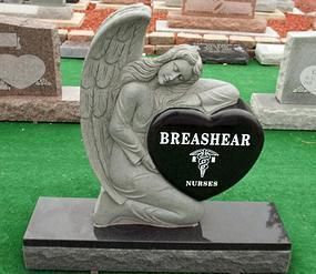 Gray angel statue tombstone with black plaque reading “BREASHEAR NUNES” on a black base.