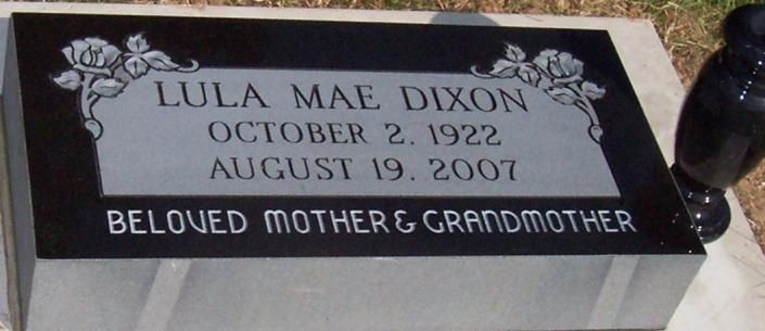 Black gravestone with white text: 
