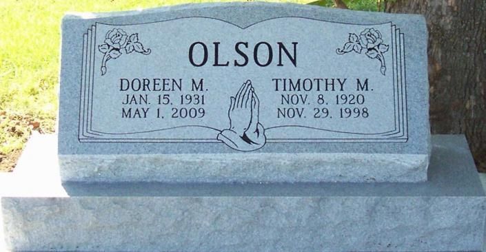 Gray Olson gravestone with names Doreen M. and Timothy B. and dates engraved on the marker