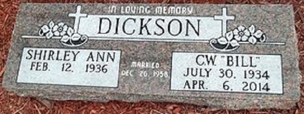 Gray gravestone plaque for Dick and Shirley Ann, with names and dates engraved, topped by small crosses