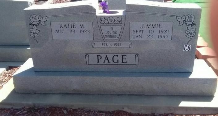 Gray gravestone with the name PAGE and two engraved plaques on a sunlit base.