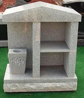 Gray granite memorial niche with roof, shelves, and a small flower holder on the left side