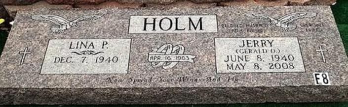 Gravestone with the name HOLM and memorial plaques for Tina P. and Jerry D. on a stone base.