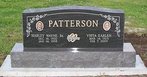 Black granite PATTERSON gravestone with engraved names and dates on a gray base
