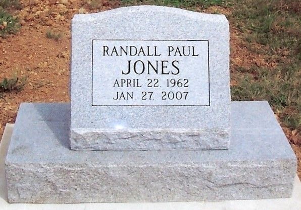Gravestone for Randall Paul Jones with birth and death dates in a cemetery.