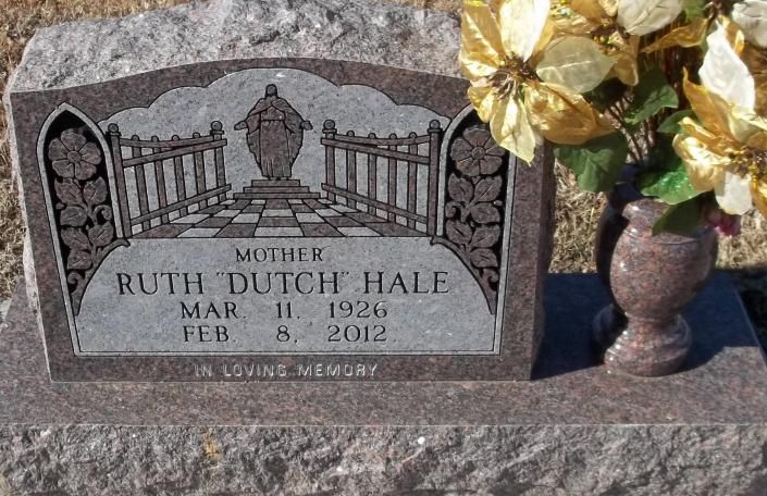 Gravestone for Ruth Dutsch Hale with flowers beside it in a cemetery