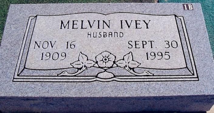 Gray gravestone plaque engraved “Melvin Ivey,” husband, Nov. 16, 1909–Sept. 30, 1995, with roses.