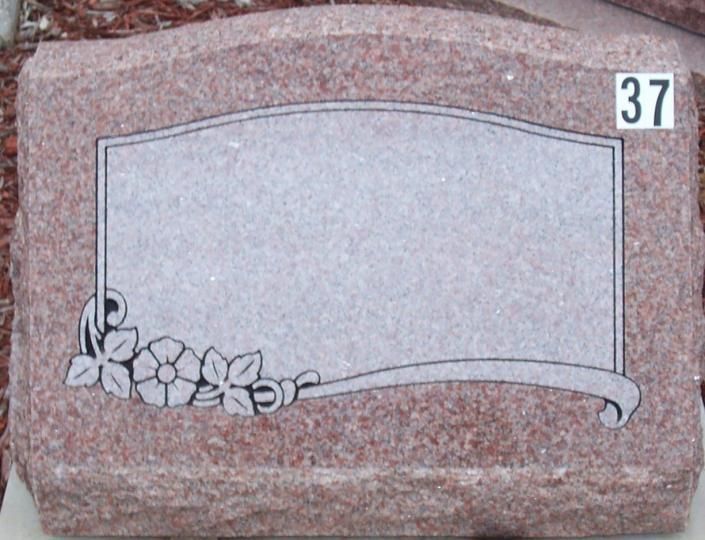 Blank granite gravestone with floral engraving and number 37 on top right