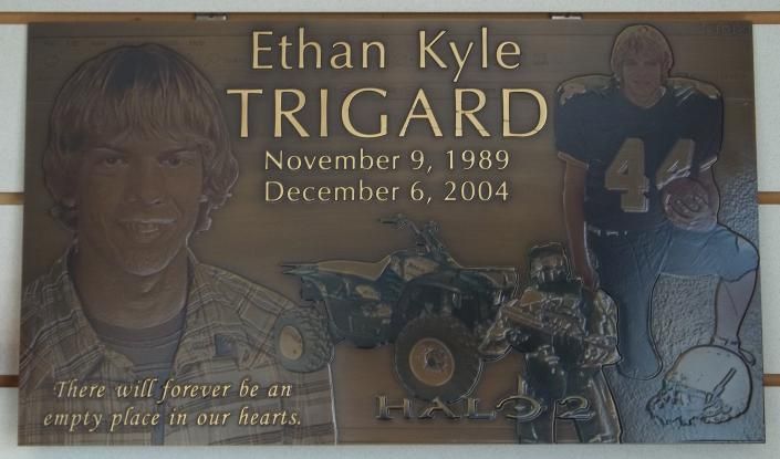 Memorial plaque with portraits of Ethan Kyle Trigard, dates November 9, 1989–December 6, 2004, and a race car.