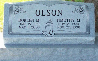Gray gravestone engraved “OLSON” with praying hands and names Doreen M. and Timothy M.