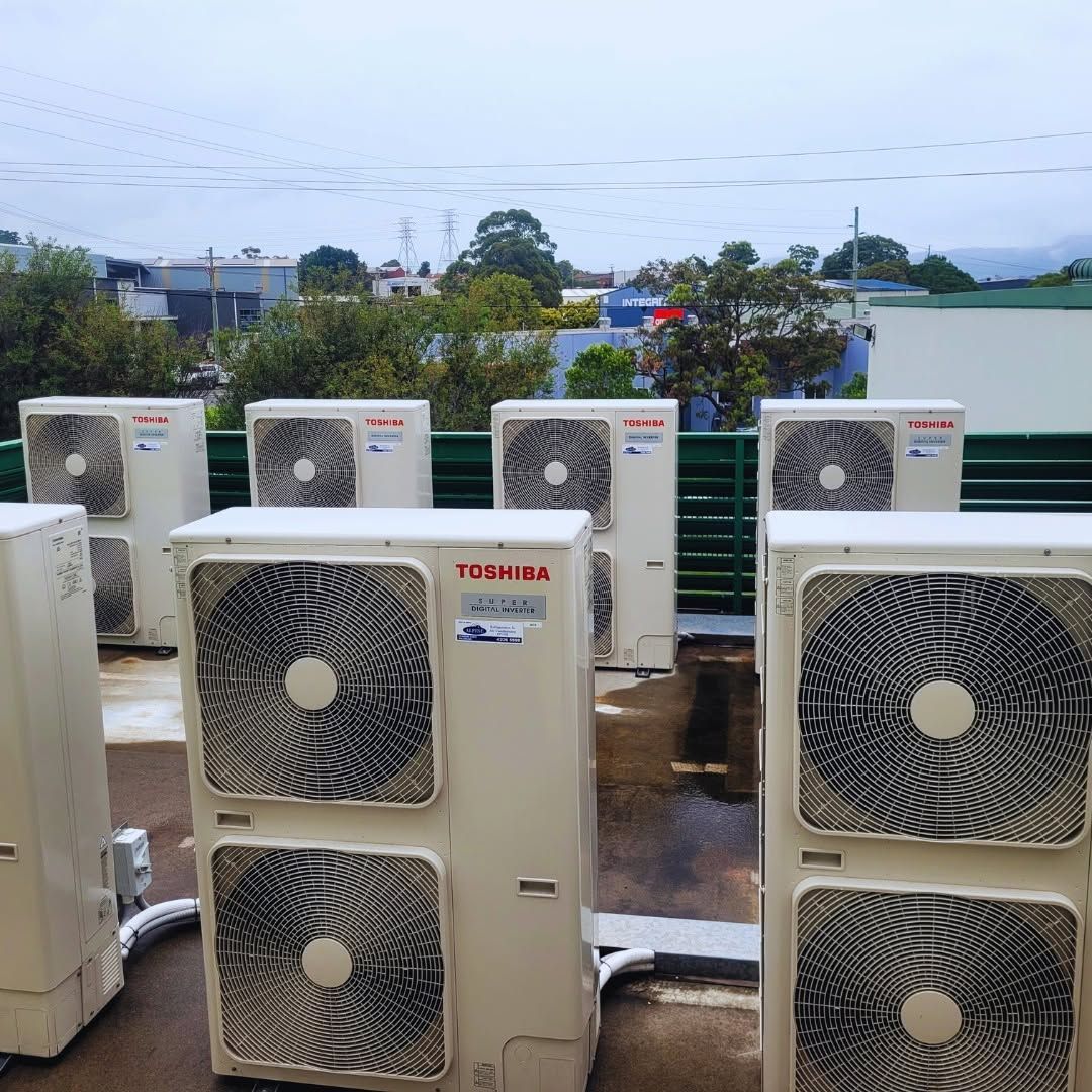 Outdoor Row of White Air-Conditioning Units on A Rooftop — Alpine Refrigeration & Air Conditioning Pty Ltd in Wollongong, NSW