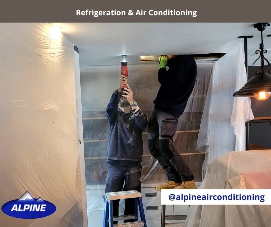 Technicians Repairing Ceiling Hvac Ducting With a Drill — Alpine Refrigeration & Air Conditioning Pty Ltd in Wollongong, NSW