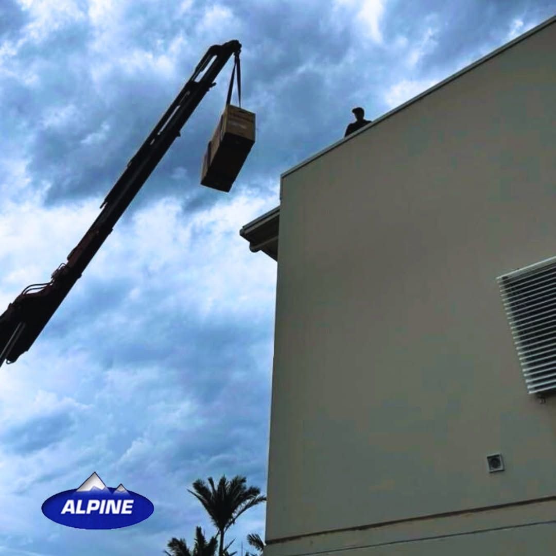 Crane Lifting a Container Above a Building Roof — Alpine Refrigeration & Air Conditioning Pty Ltd in Wollongong, NSW