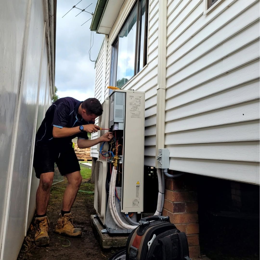 Technician Repairing Outdoor Hvac Unit — Alpine Refrigeration & Air Conditioning Pty Ltd in Wollongong, NSW
