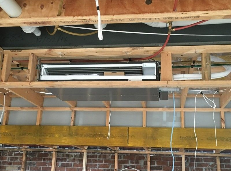 Exposed Ceiling with A Wall-Mounted Hvac Unit — Alpine Refrigeration & Air Conditioning Pty Ltd in Wollongong, NSW