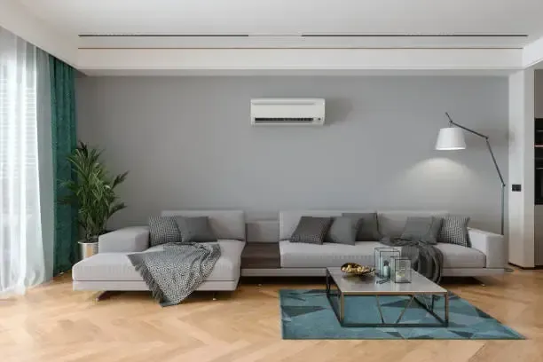 Modern Living Room With Gray Sectional Sofa — Alpine Refrigeration & Air Conditioning in Wollongong, NSW Modern Living Room With Gray Sectional Sofa — Alpine Refrigeration & Air Conditioning in Wollongong, NSW
