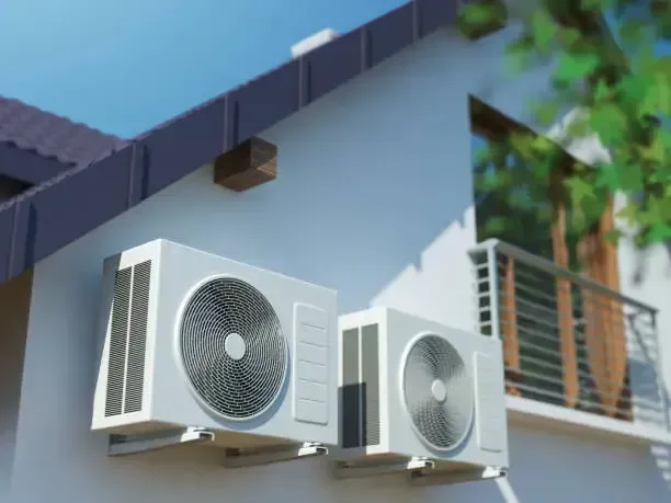 Two White Outdoor Air Conditioner Units Mounted on A Building Wall — Alpine Refrigeration & Air Conditioning Pty Ltd in Wollongong, NSW