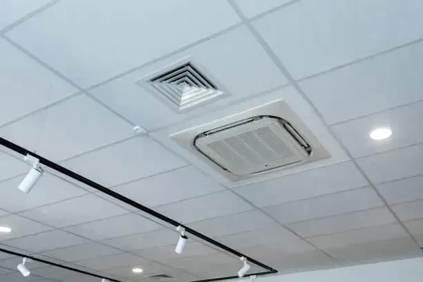 Ceiling With White Tiles, Air Vents, And Track Lighting — Alpine Refrigeration & Air Conditioning in Wollongong, NSW Ceiling With White Tiles, Air Vents, And Track Lighting — Alpine Refrigeration & Air Conditioning Pty Ltd in Wollongong, NSW