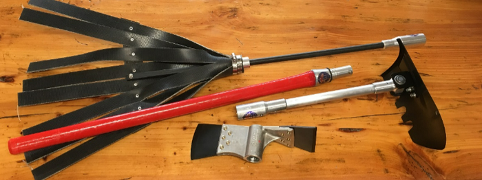 Black and red tools and parts laid out on a wooden surface, including rods, blades, and a clamp-like piece
