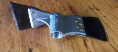 Metal scraper tool with black handles on a wooden surface