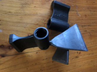 Black plastic propeller blade assembly on a wooden surface