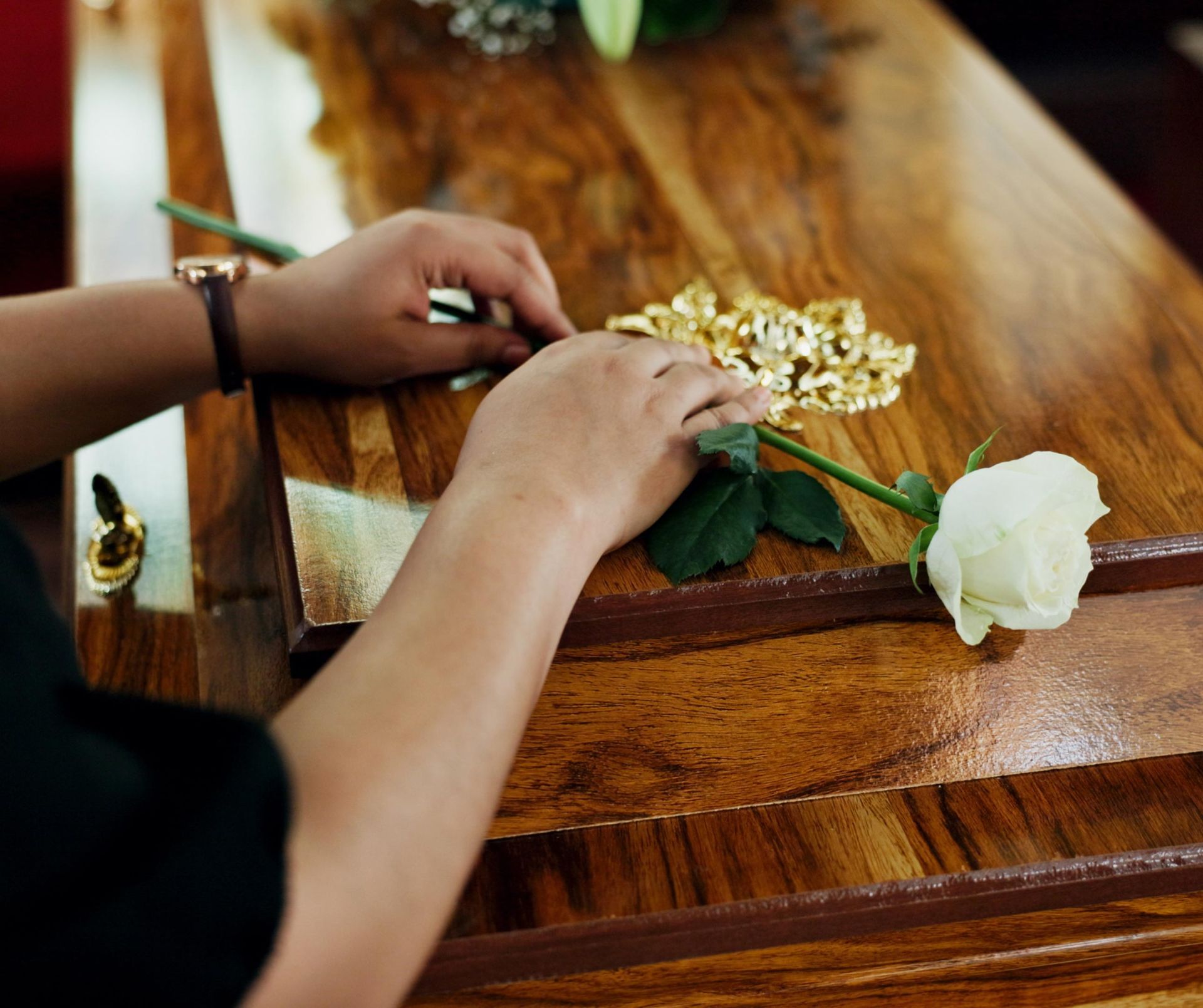 White rose on a wood coffin.
